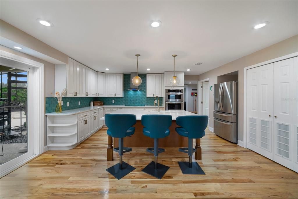 The kitchen was crafted with the home chef in mind offering UPGRADED STAINLESS STEEL APPLIANCES, a chic color palette accented by gold hardware, a whimsical backsplash, huge CENTER ISLAND finished in darker wood and an 8x8 WALK-IN PANTRY for all your storage needs.