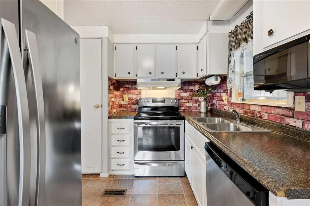 Kitchen has stainless steel appliances.