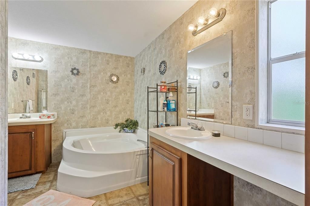 Main bathroom has step-in shower and large tub.