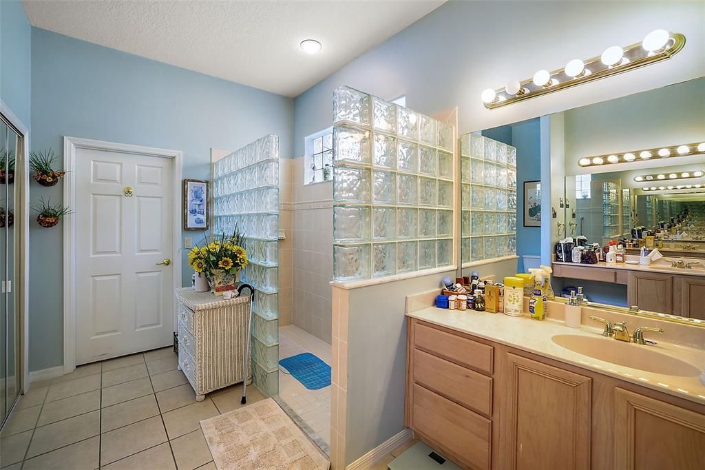 Primary Bath - 12X10 - with custom Glassed Walk-In Shower and TWO Vanities PLUS a -- Walk-In Closet (08X10).