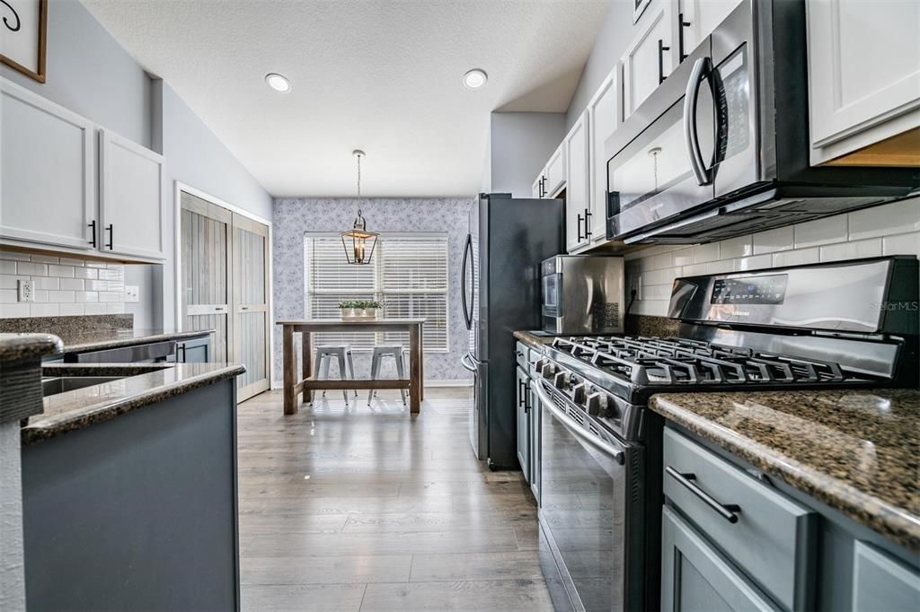 Tiled backsplash, recessed lighting and high ceilings