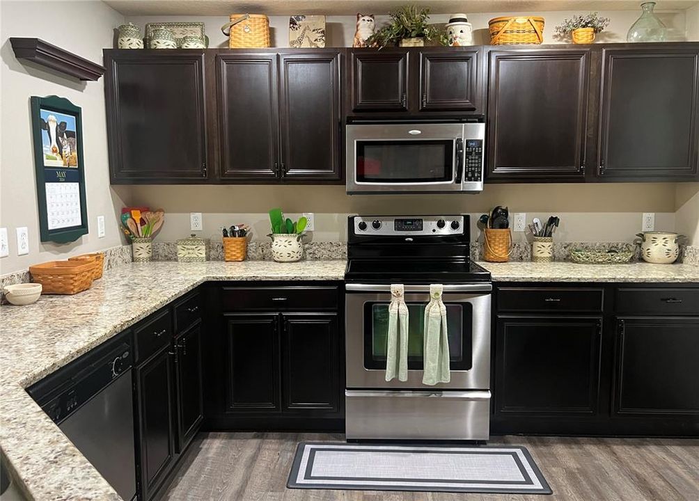 The kitchen features granite countertops, expresso cabinets, and SS appliances!