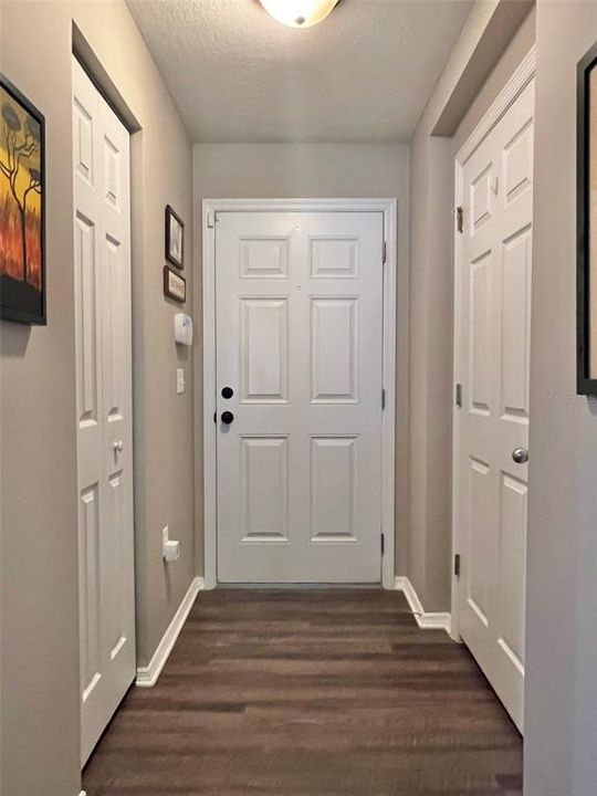As you enter, the half bathroom and a deep coat closet is just inside.  Luxury Vinyl Plank flooring is literally EVERYWHERE in this home!