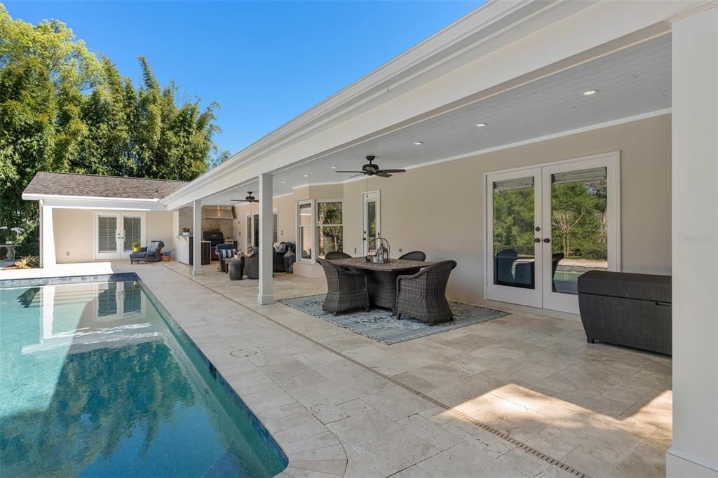 Large, Outdoor Covered terrace with travertine