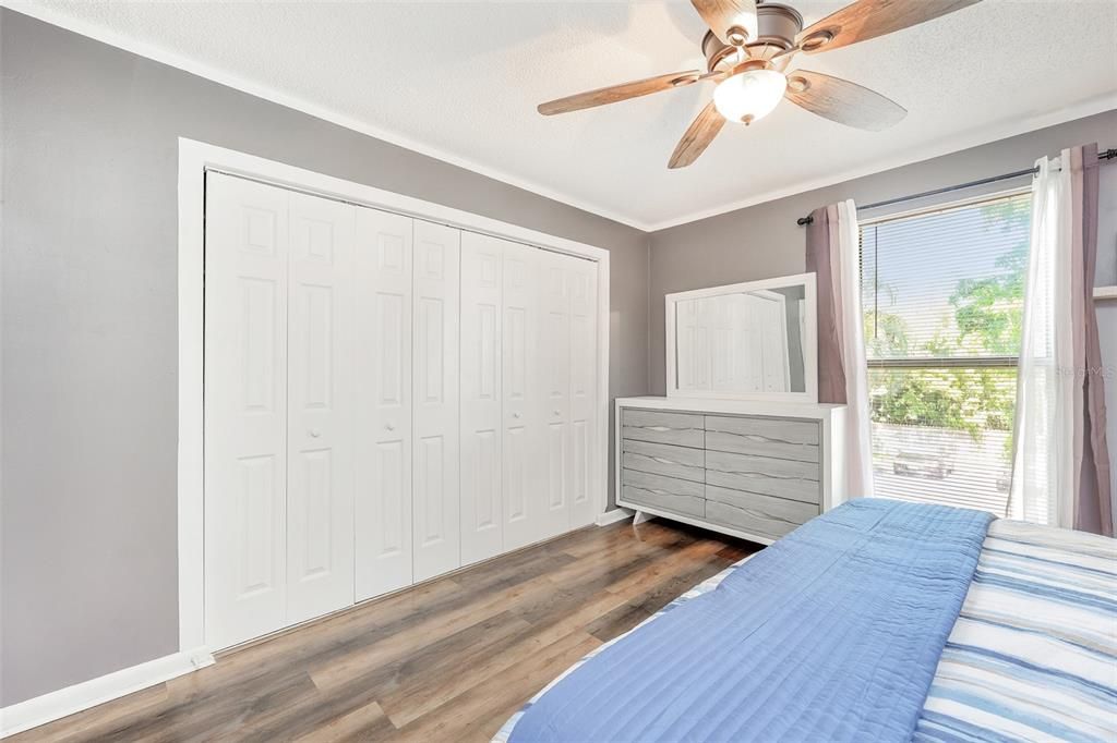 Bedroom with a closet, ceiling fan, and hardwood / wood-style floors