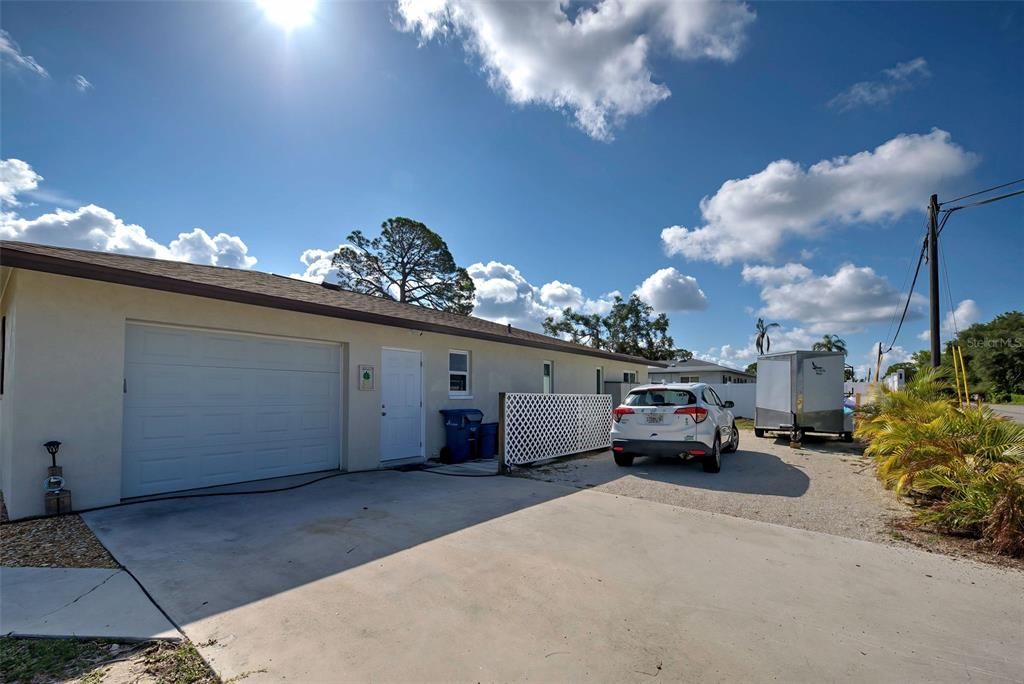 Driveway on the side of the house. Note the extra parking and there is a storage shed also.