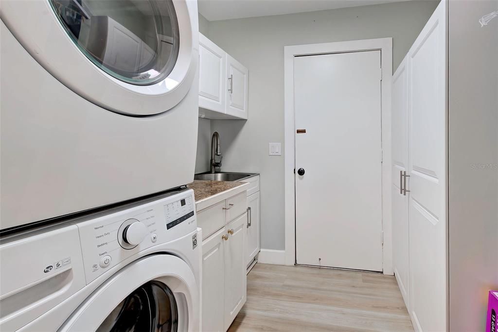 Indoor laundry with exit to garage