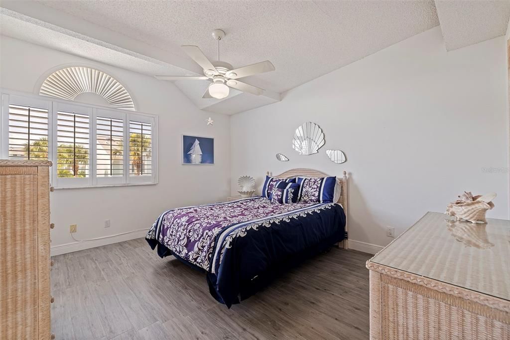 Primary bedroom with walk-in closet and tasteful plantation shutters