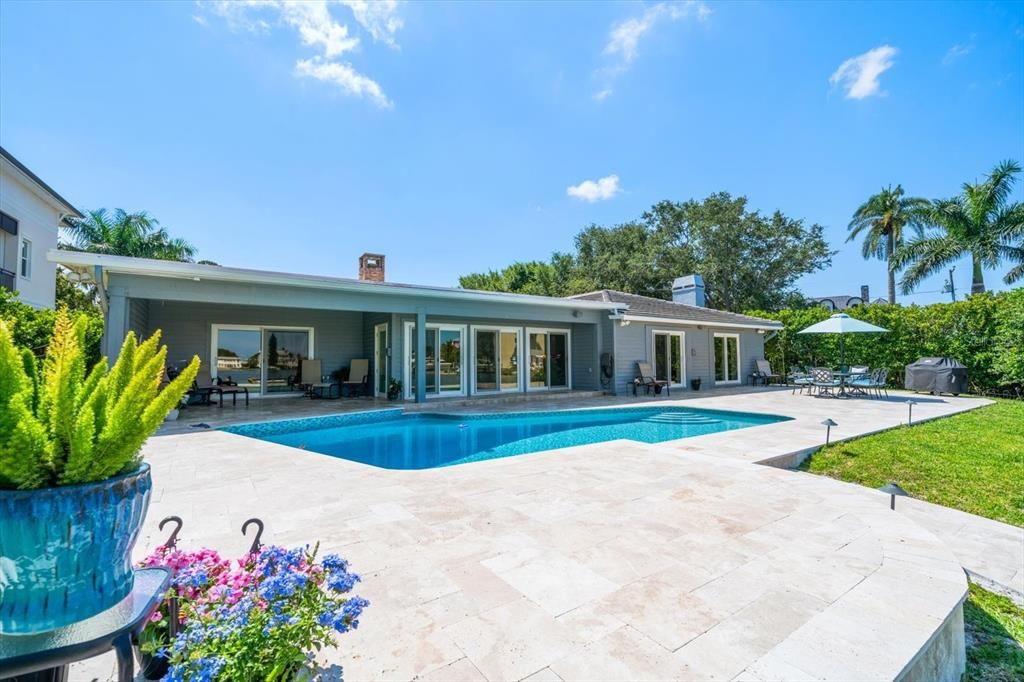 Charming and lovely residence with covered patio, abundant deck for entertaining and lovely oversized pool.