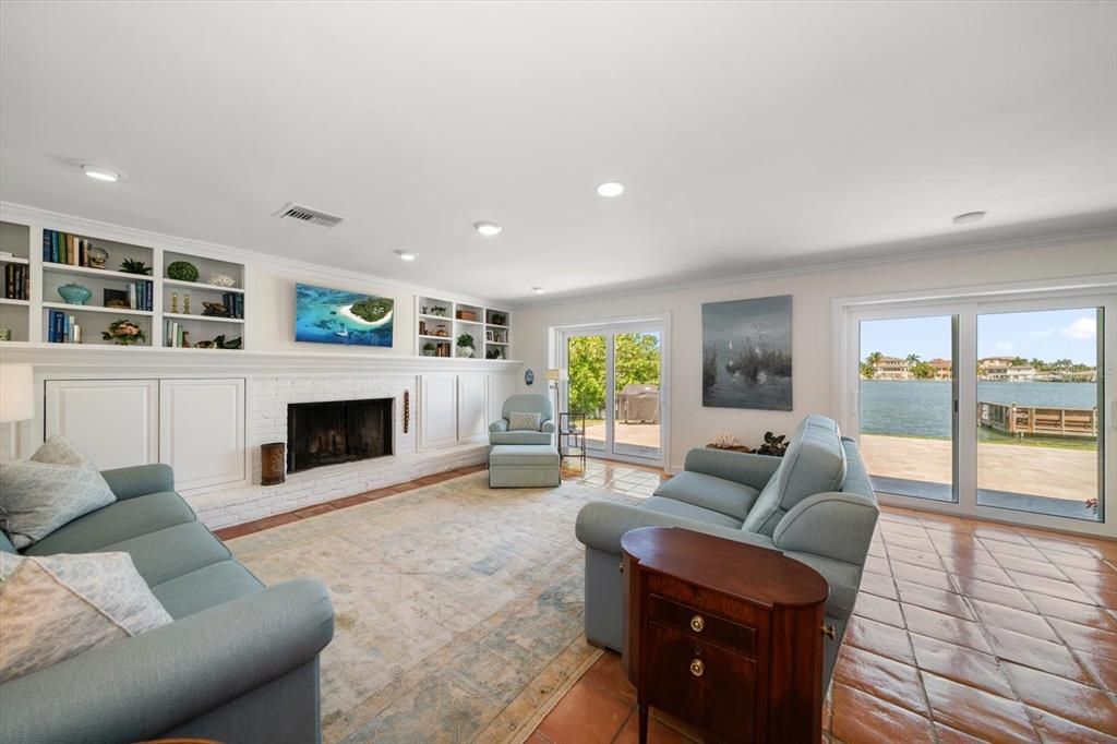 Family room extends to outdoor vistas bathed in natural light.