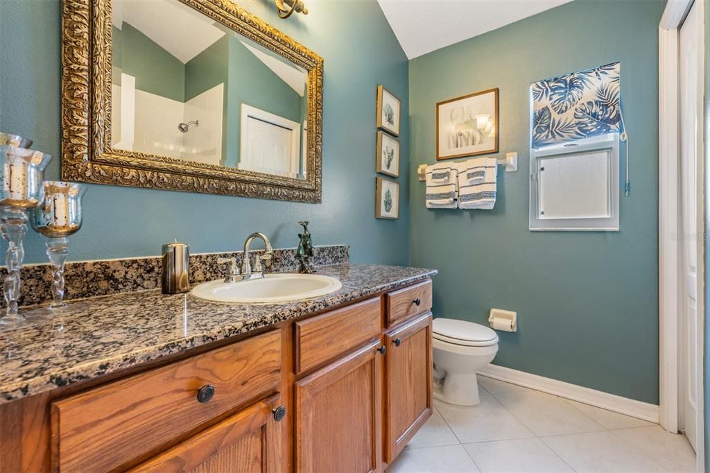 Guest Bathroom, granite countertop and tile flooring.