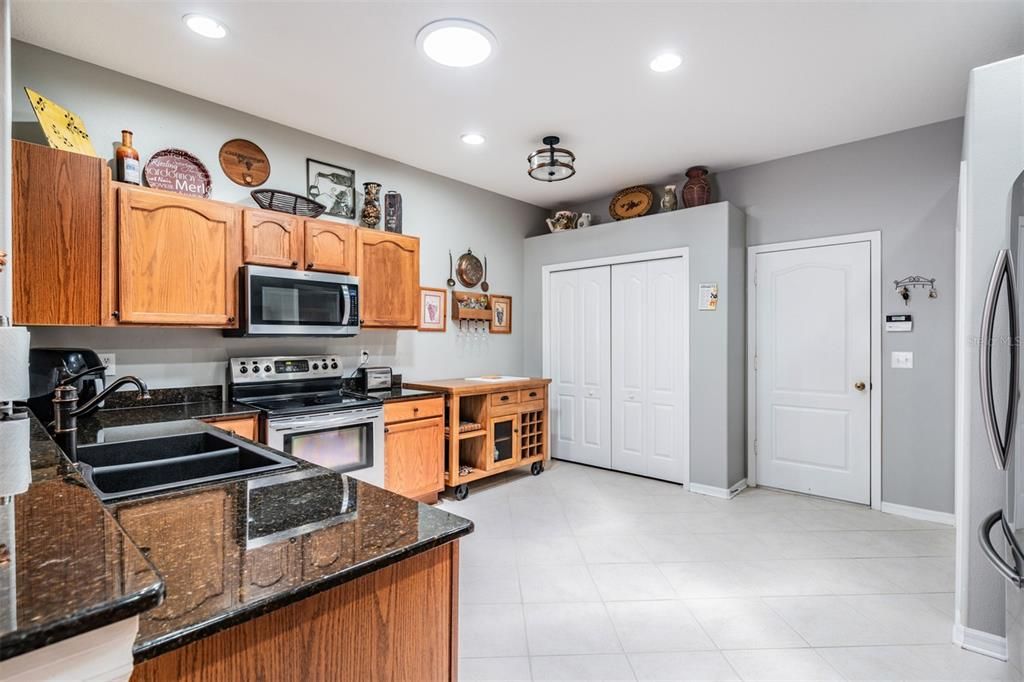 Diagonal tile flooring, inset lighting, stainless steel appliances, room to eat in the kitchen area.