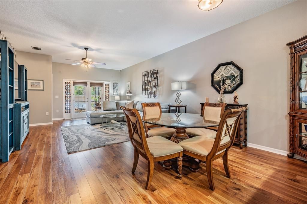 Dining room open to the family room, ceiling fan and updated flooring.