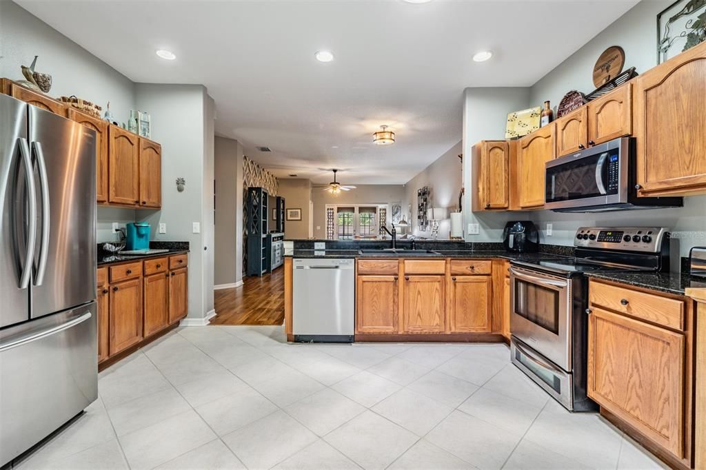 Diagonal tile flooring, inset lighting, stainless steel appliances, room to eat in the kitchen area.