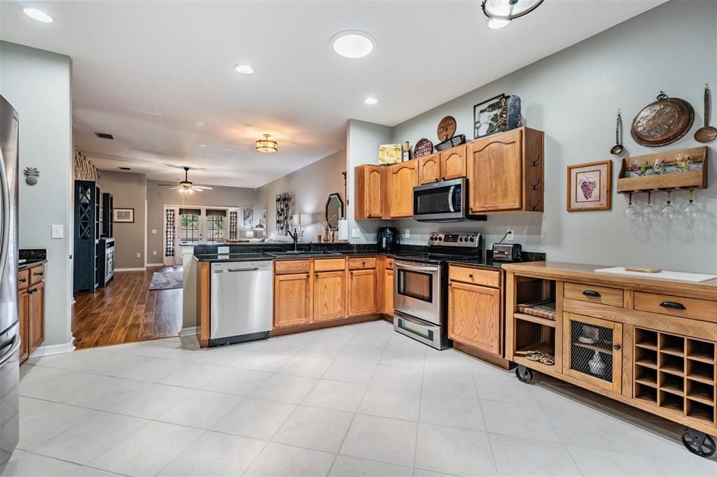 Diagonal tile flooring, inset lighting, stainless steel appliances, room to eat in the kitchen area.