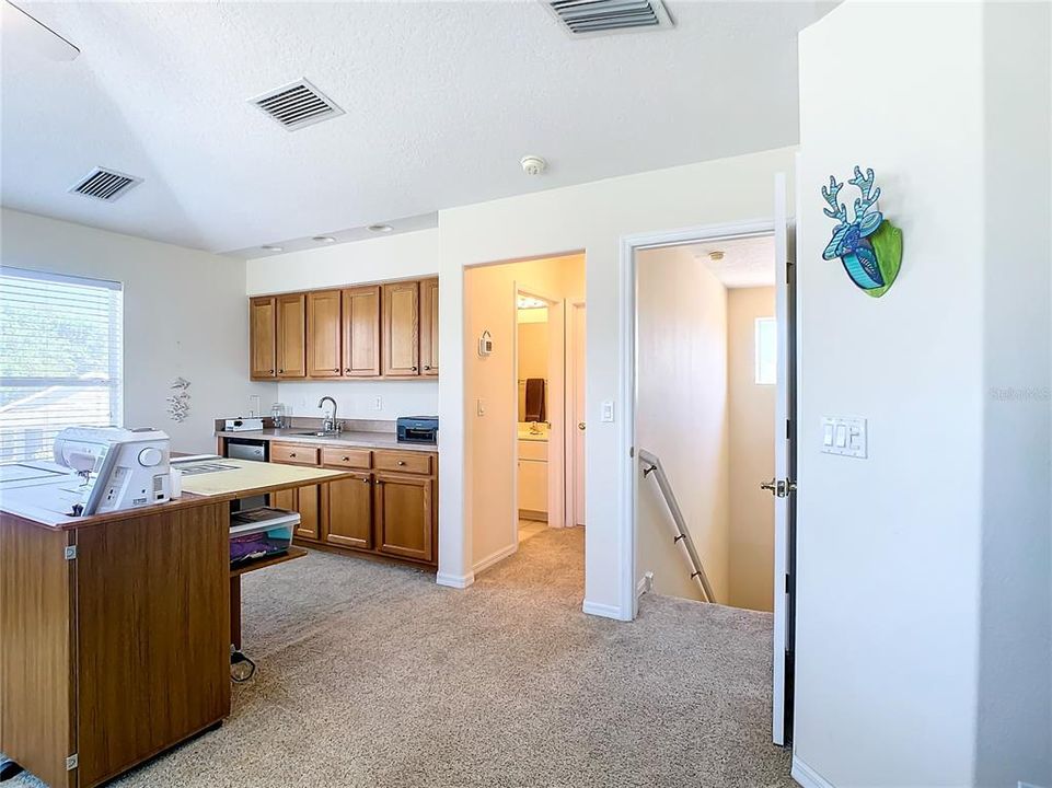 Upstairs Bonus Room with wet bar, full bath, and 2 storage closets