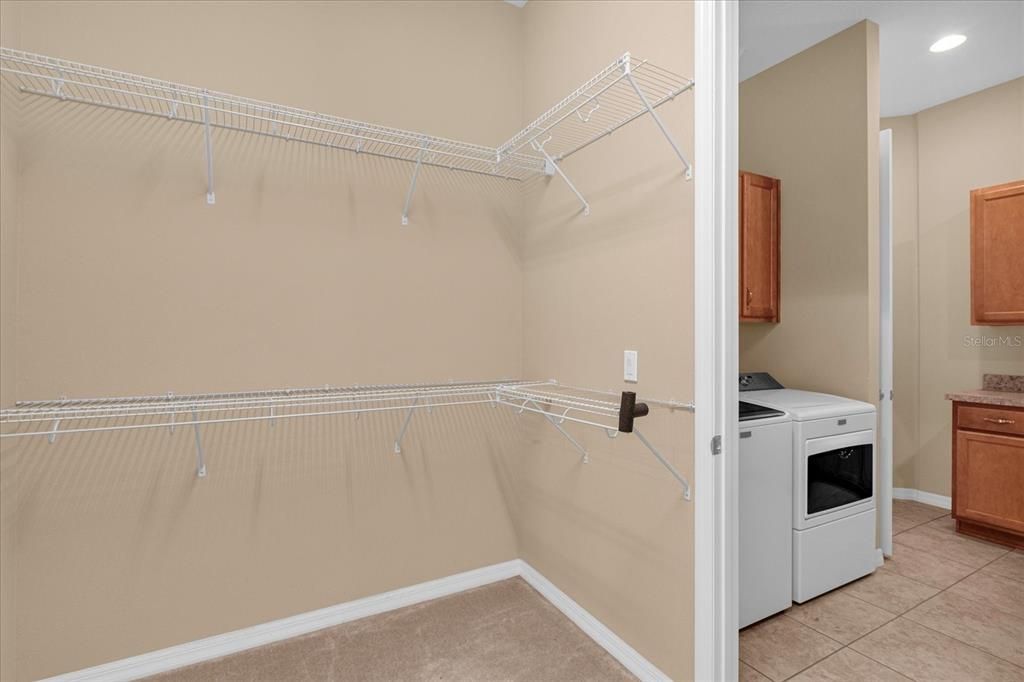 Primary walk-in closet leads to Laundry