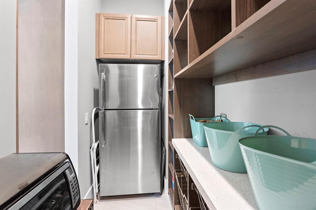 pantry with additional fridge and tons of storage!