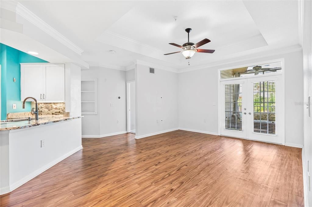 Living room with tray ceiling and open floor plan.