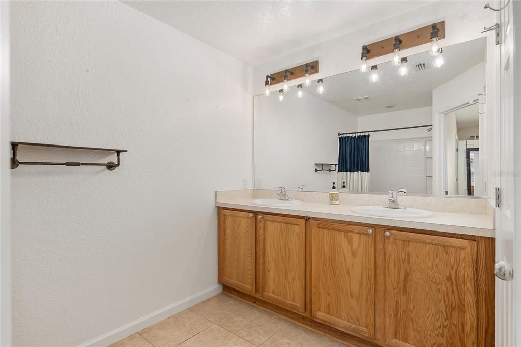 Master bathroom with his/her sinks and upgraded lighting