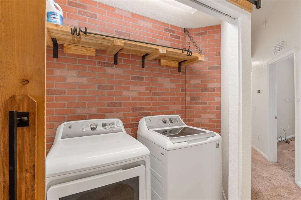 Upstairs laundry room with faux brick detail