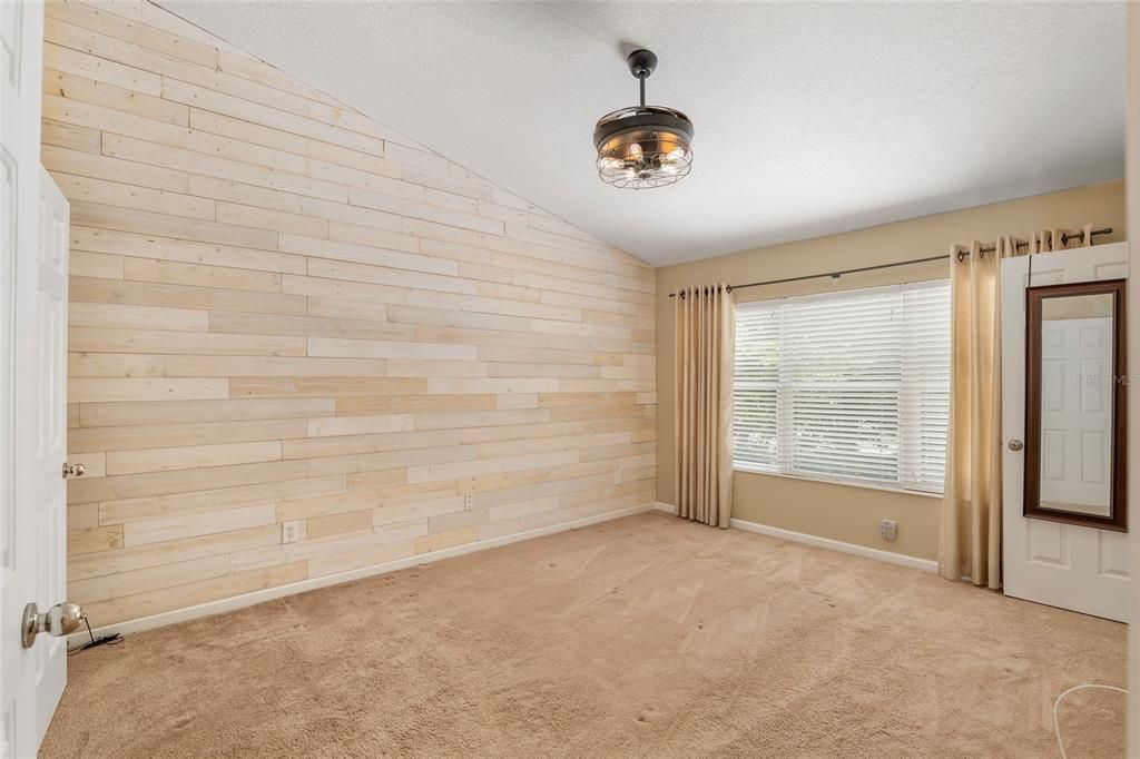 Master bedroom with shiplap reclaimed wood wall