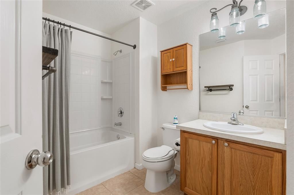 Guest bathroom upstairs with upgraded, rustic light fixtures