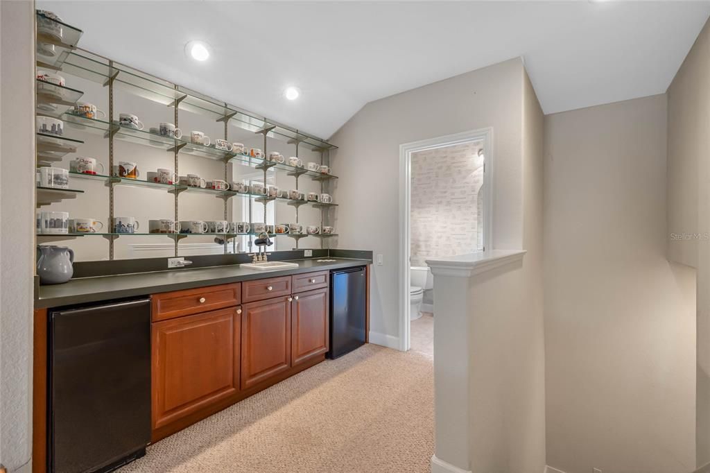 Cabinetry and entry to half bath upstairs