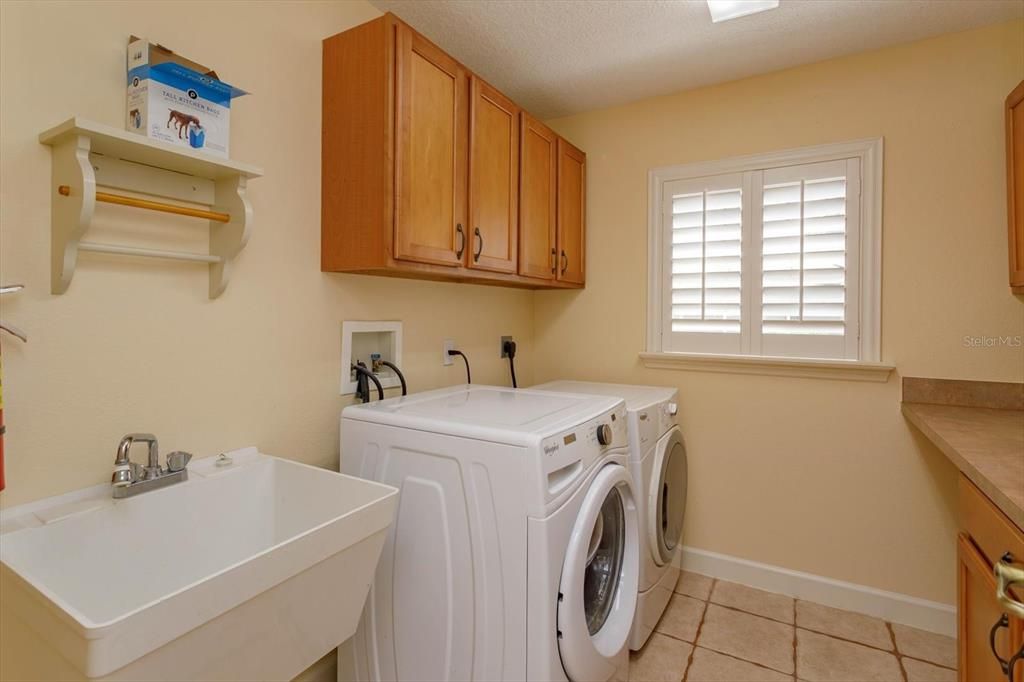 Laundry room - has cabinets on both walls and lower cabinets with folding counter (not shown)