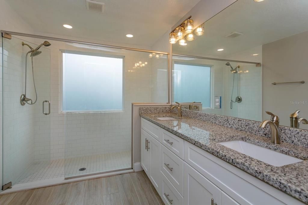 Primary bath with granite topped vanity and 2 sinks