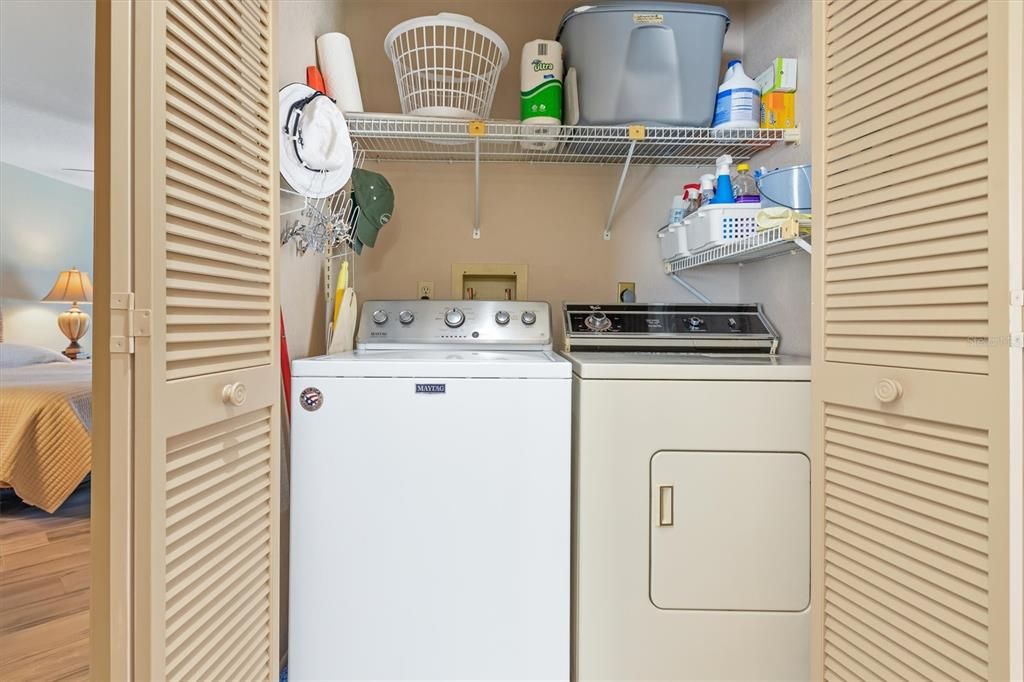 Handy laundry closet in hall by primary bedroom.