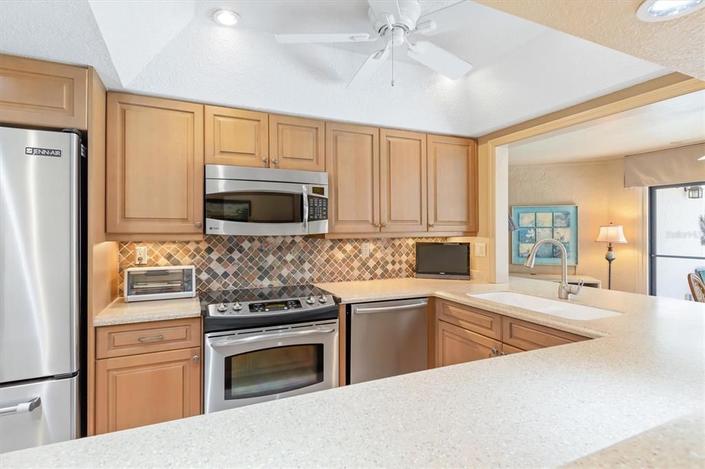 Hard surface nuetral countertops.  Under cabinet lighting. Ceiling fan and updated lights.