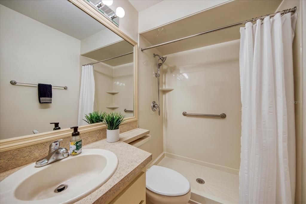 The hall bathroom is in between bedrooms 2 and 3. It features a new step in shower with safety bar & built in shelves.