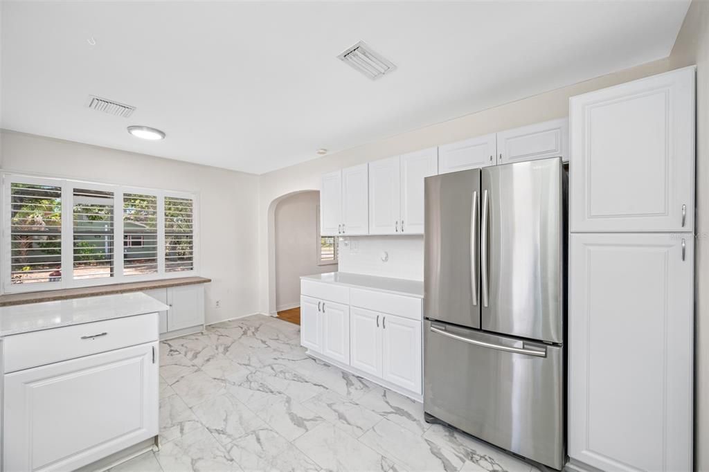 Updated Kitchen with shaker cabinets, granite counters, new stainless-steel appliances.