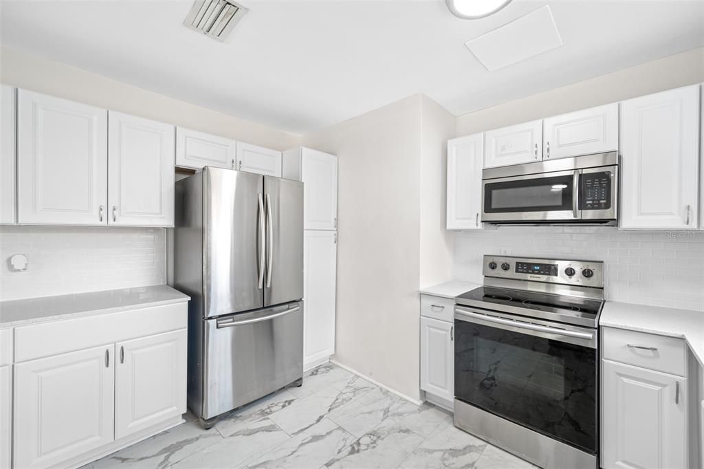 Updated Kitchen with shaker cabinets, granite counters, new stainless-steel appliances.
