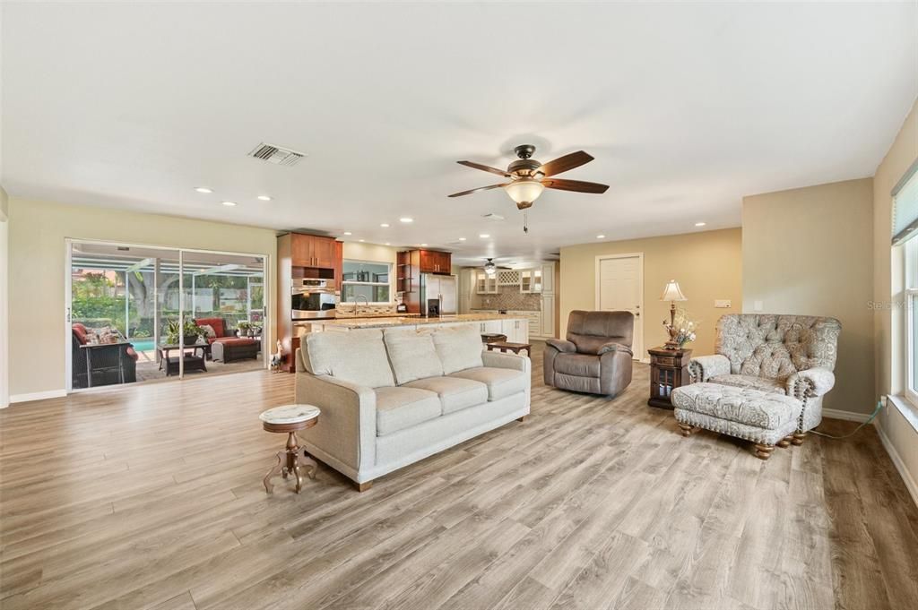 Living Room Open To Kitchen With Large Sliders To Pool And Lanai