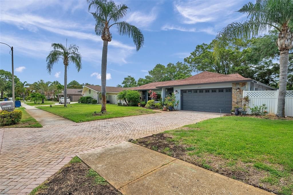 Exterior Showcasing Royal Palms And Paver Driveway