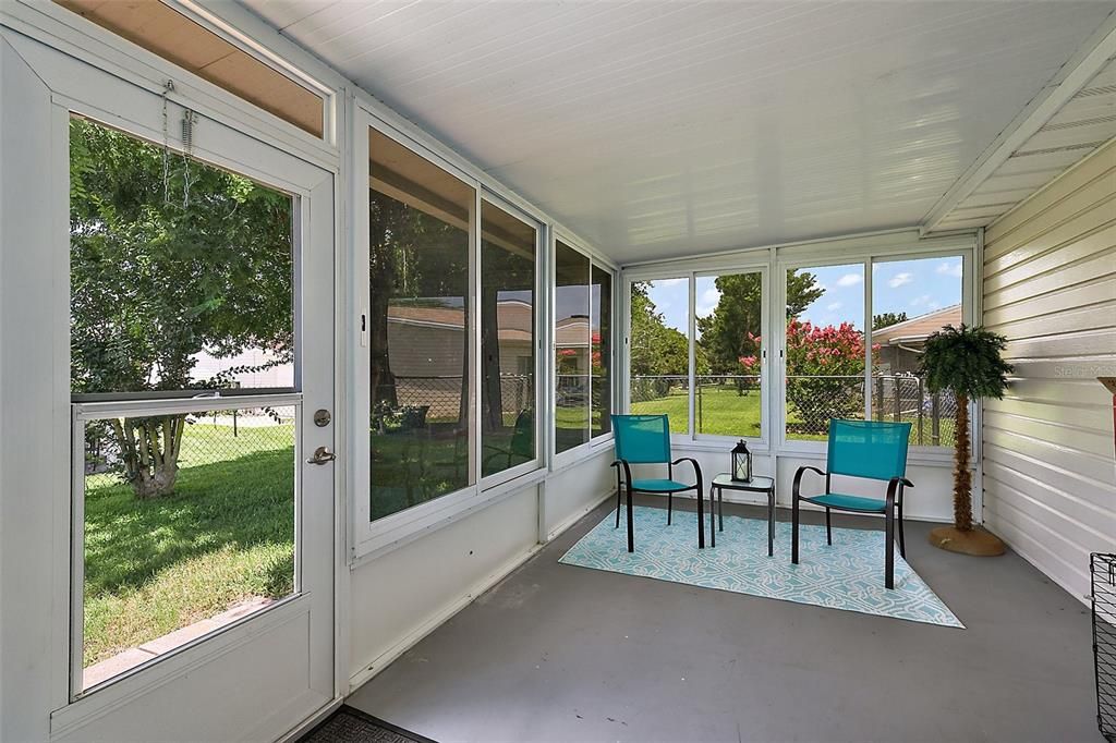 Enclosed lanai with door to fenced backyard