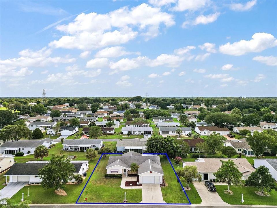 Aerial view of property from the front and showing more of the Spruce Creek South neighborhood