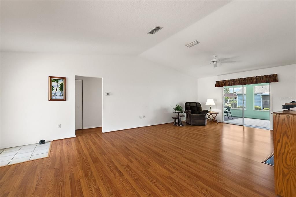 Spacious great room looking toward back - note the vaulted ceiling