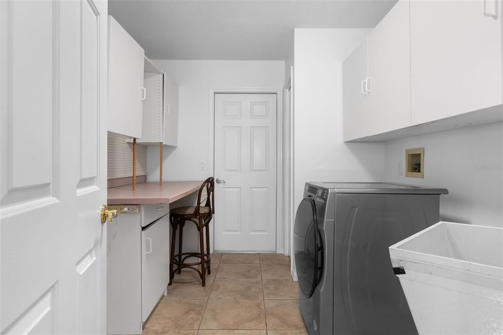 Inside Laundry Room with sink and cabinets