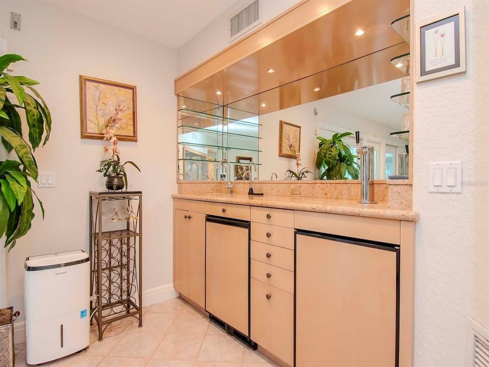 Wet Bar with Beverage refrigerator, keg cooler and liquor dispenser.