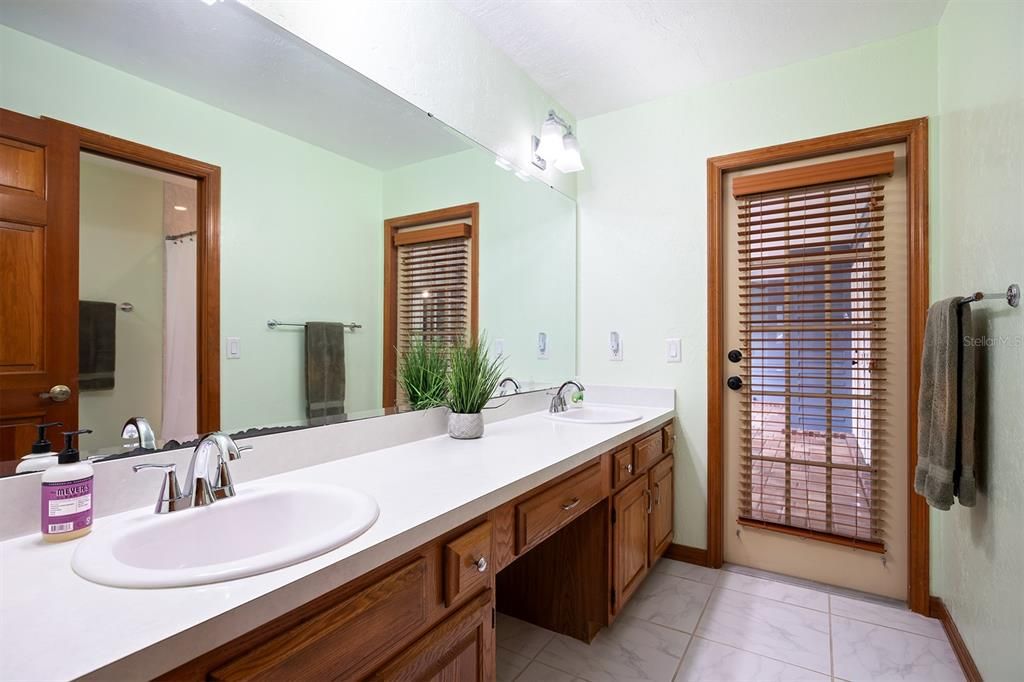 Bathroom 2 with double sinks and pool bath door.