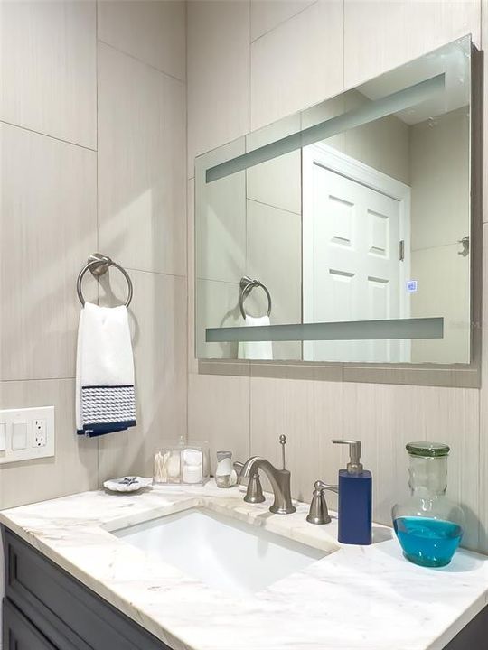 Updated Guest Bath with solid surface counter & mirror with light strips