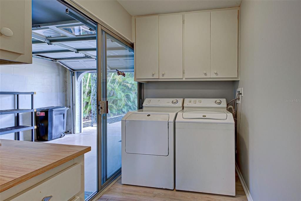 Laundry room with storage is located off the kitchen. Sliding glass door to the garage.