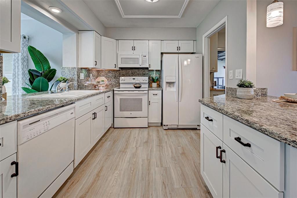 Beautifully renovated kitchen with new cabinetry and granite counters