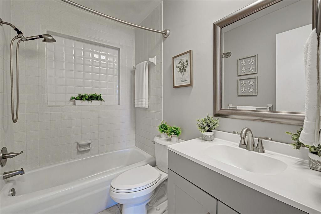 Guest bath located in hallway between bedrooms