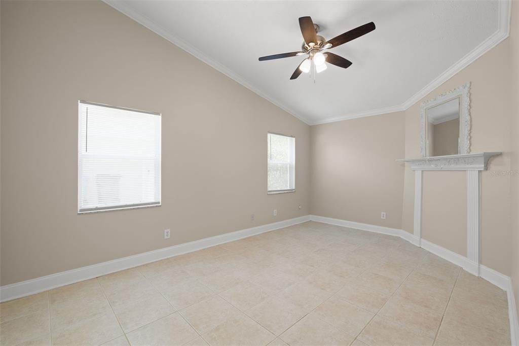 Primary bedroom includes crown molding and tile throughout the house.