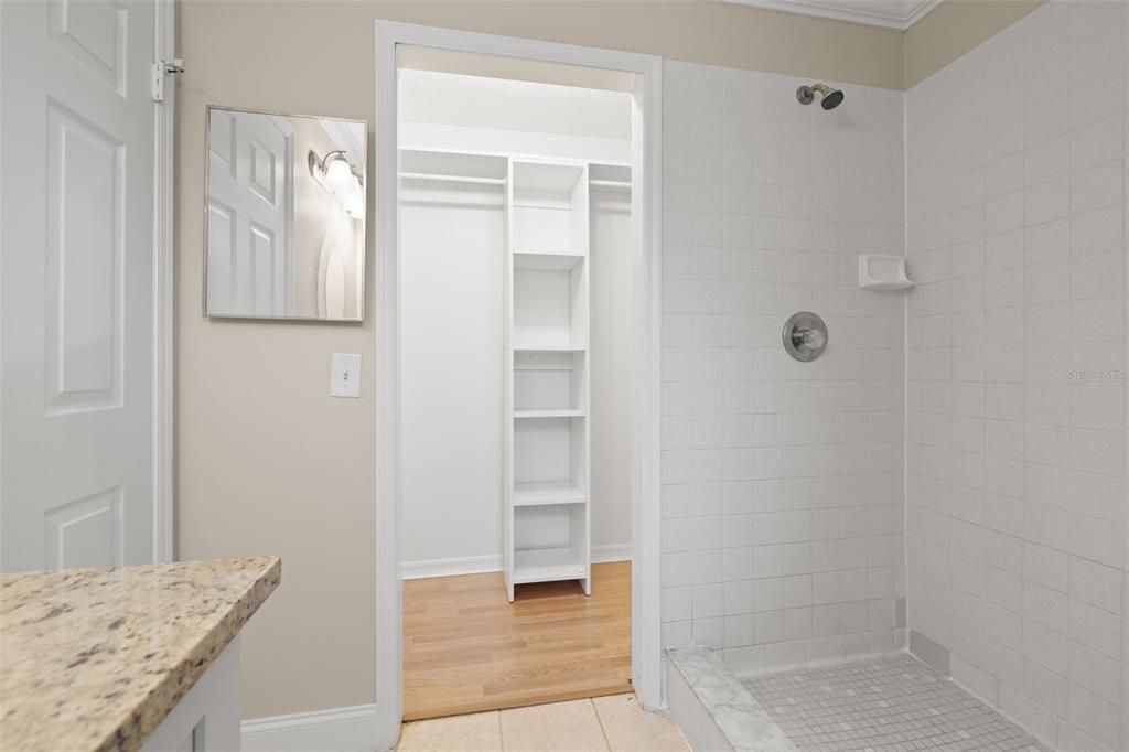 Walk in closet in the primary bathroom.