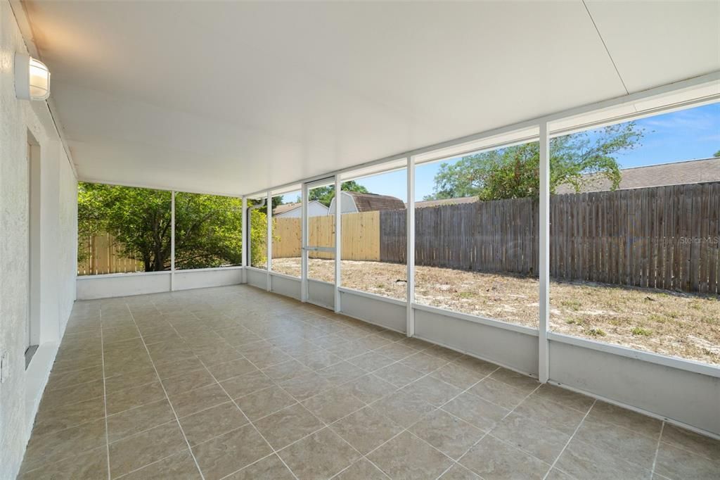 Large screened patio and fenced backyard.